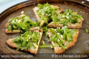 Cheesy and Garlicky White Pizza topped with Fresh Arugula 