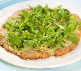 Cheesy and Garlicky White Pizza topped with Fresh Arugula 