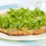 Cheesy and Garlicky White Pizza topped with Fresh Arugula 