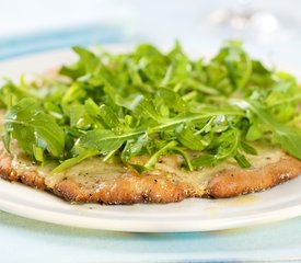 Cheesy and Garlicky White Pizza topped with Fresh Arugula 