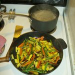 Cooking sesaonal veggies and noodles for the Pad Thai.