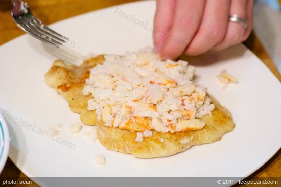 Plating the chicken, top with the crab meat