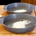 Add flour into greased pans.