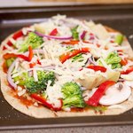 Sprinkle the remaining cheese on top, pop the pizzas into the oven.
