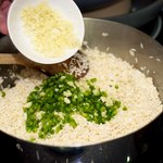 Adding the garlic to the rice and jalapenos