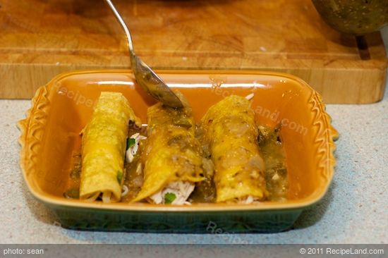 Spoon enchilada sauce over the enchiladas