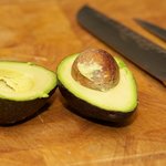 Also get the avocado ready, cut it into the half first...