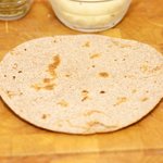 Flip the tortilla and toast until puffed and slightly browned, 1 minutes. 