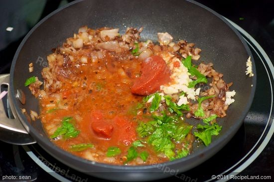 Add the tomato paste, garlic and parsley