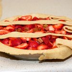 Fold back the first, third and fifth strips of dough to the edge of the pie.