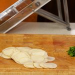 The potatoes, very thinly sliced