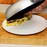 Invert and fold the omelette, rolling onto the plate