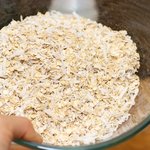 In a large bowl, stir oats and coconut until well distributed.