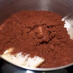 In large saucepan, place butter, milk, sugar, vanilla, a pinch of salt and cocoa.
