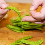 Remove the strings from the snow peas