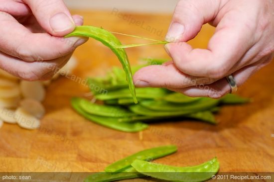 Remove the strings from the snow peas