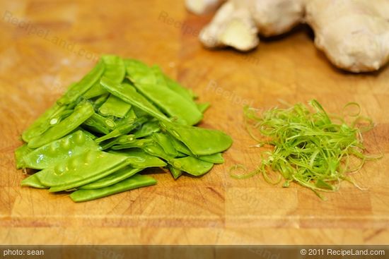 Strings are removed from the snow peas