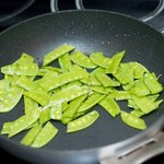 Stir-fry the snow peas