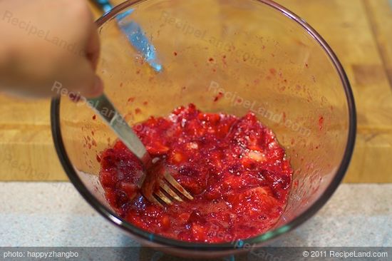 Mash the strawberries with a fork in a large bowl...