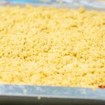 Sprinkle the prepared topping evenly over batter, and lay foil on lower rack to catch any juicy fruit spillovers.