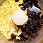 Add the peeled garlic, finely chopped ginger, and the raisins into a food processor...
