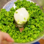 Add the partially mashed peas into the food processor bowl...