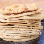 Keep repeating the same steps until all the small balls turn into these lovely naan breads...