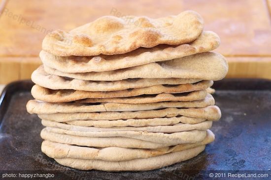 Keep repeating the same steps until all the small balls turn into these lovely naan breads...