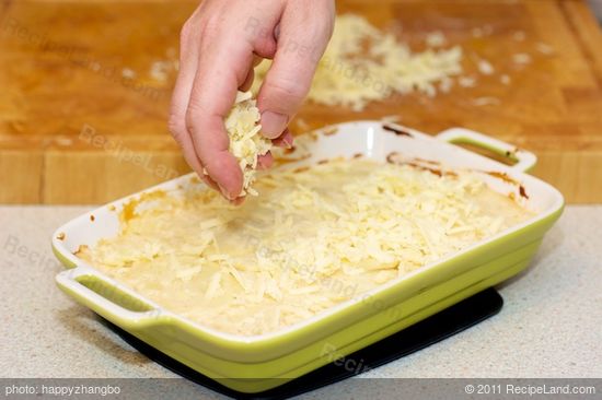 Sprinkle the cheese evenly over baked scalloped potatoes...