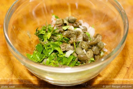 Add herbs, olive oil, honey and capers to a small bowl