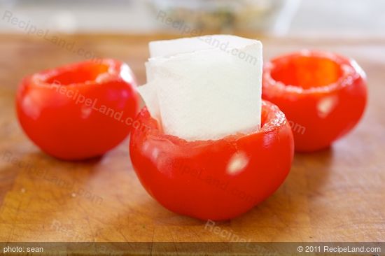 Thoroughly dry the inside of the tomato shells.