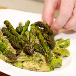 Arrange the tossed asparagus onto a serving platter,