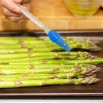 Brush the asparagus spears with the reserved 2 tablespoons of dressing.