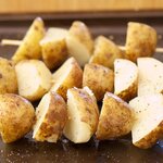Brush all sides of the cooked and cooled potatoes with the olive oil or any vegetable oil, and sprinkle with salt and black pepper to taste.