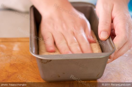 Place each cylinder of dough into one of the prepared loaf pans and gently press it...