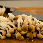 Trim off the ends of small brown mushrooms, then separate into pieces.