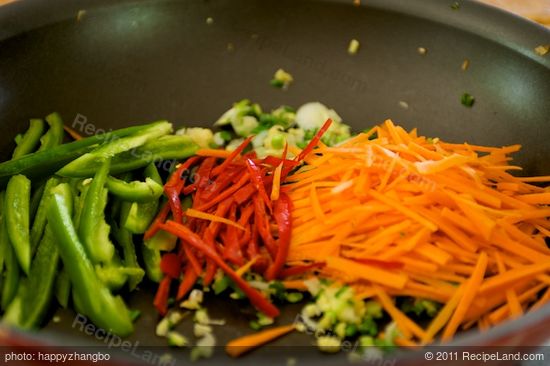 Stir in the carrots, red and green chili peppers.