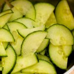 Add the sliced half-moon shape cucumber into a bowl, sprinkle the salt over, and toss until well combined.