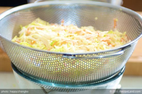 Transfer the slaw into a colander that sits over a large bowl or saucepan.