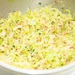 Add the slaw into a large bowl.