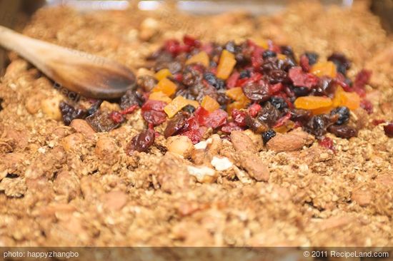 Add half of the dried fruits into each baking sheet.