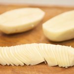 Cut potatoes in half lengthwise, then slice medium thin.