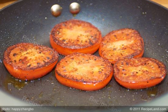 Add the tomato slices and sear on each side.