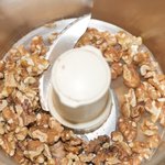 Add lightly toasted walnuts into a food processor.