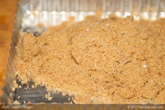 Turn the mixture out of the processor into the well-greased tart pan.