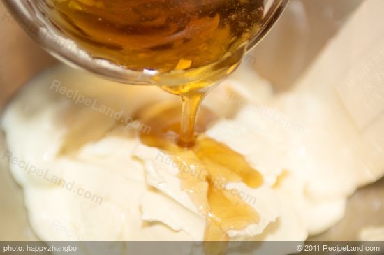 Add the sour cream and cream cheese into a large mixing bowl with an electric mixer.