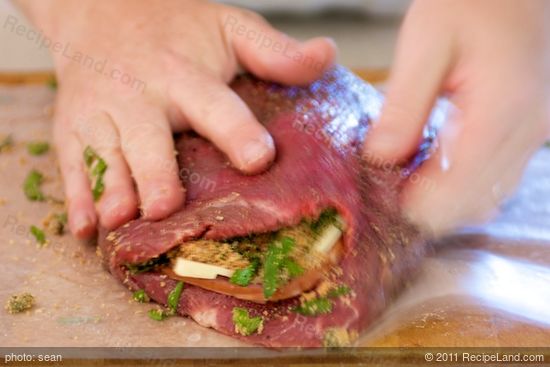 Fold in the stuffing with the other half of the flank steak