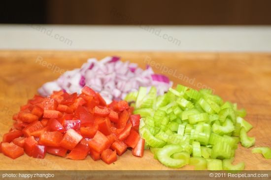 Thinly slice the celery, dice the pepper, and chop the onion.