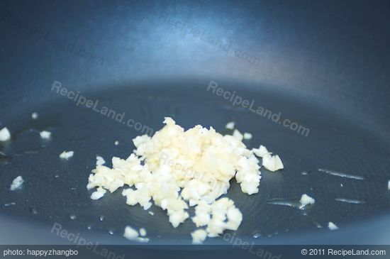 Add the garlic into a hot skillet with vegetable oil added.