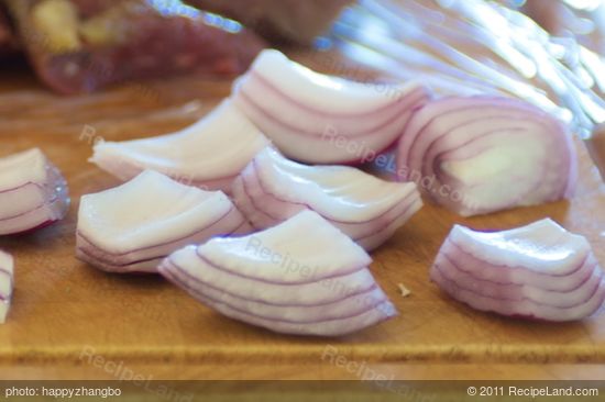 Peel and cut the onion into quarters.